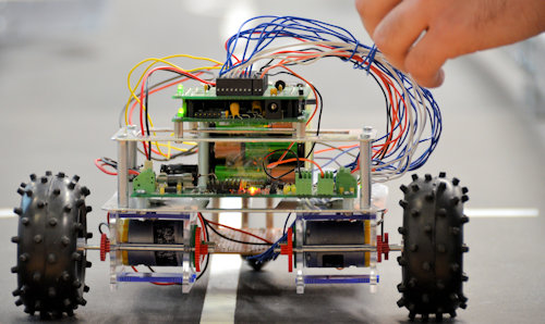 A small robotic car, with inner workings exposed