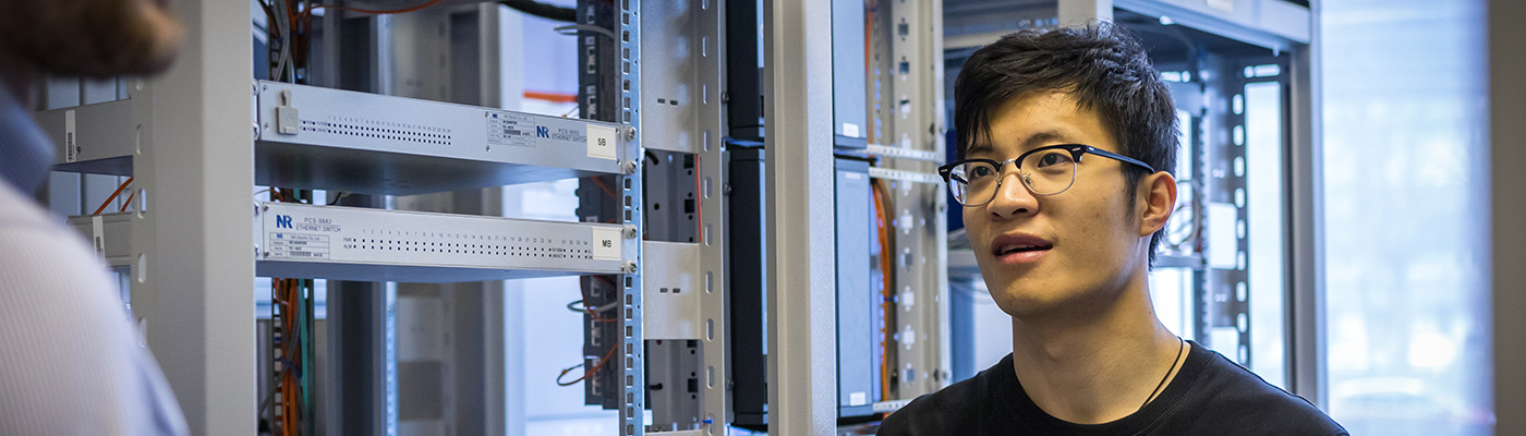 A male student in the RTDS lab