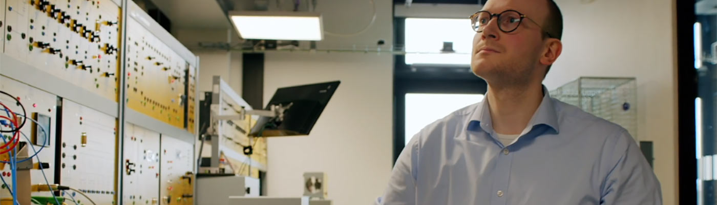 Member of staff looking at a power circuit board