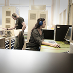 Two researchers operating computer equipment