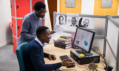 GDI students around a computer