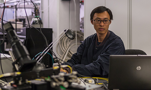 Researcher consulting his laptop as he works in the PSI