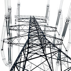 Ground view of electricity pylon in front of overcast sky