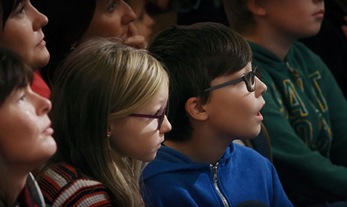 Two primary school students staring in amazement at Robot Orchestra