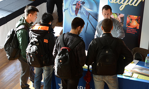 Students asking questions at a careers fair