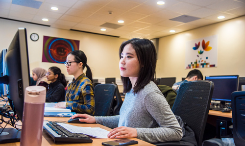 Students in computer room focusing on screens