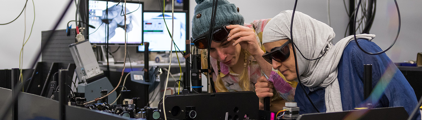 Two female students conducting research at the Photon Science Institute