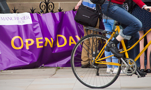 A bicycle in front of an open days banner