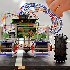 Hand adjusting wires on robot